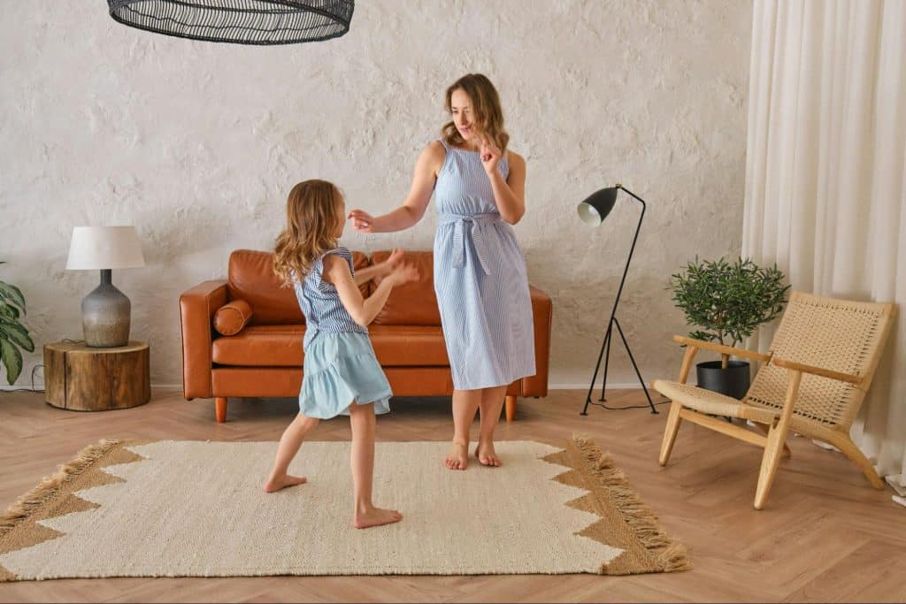 Caregiver and child moving together at home during a calm moment of care