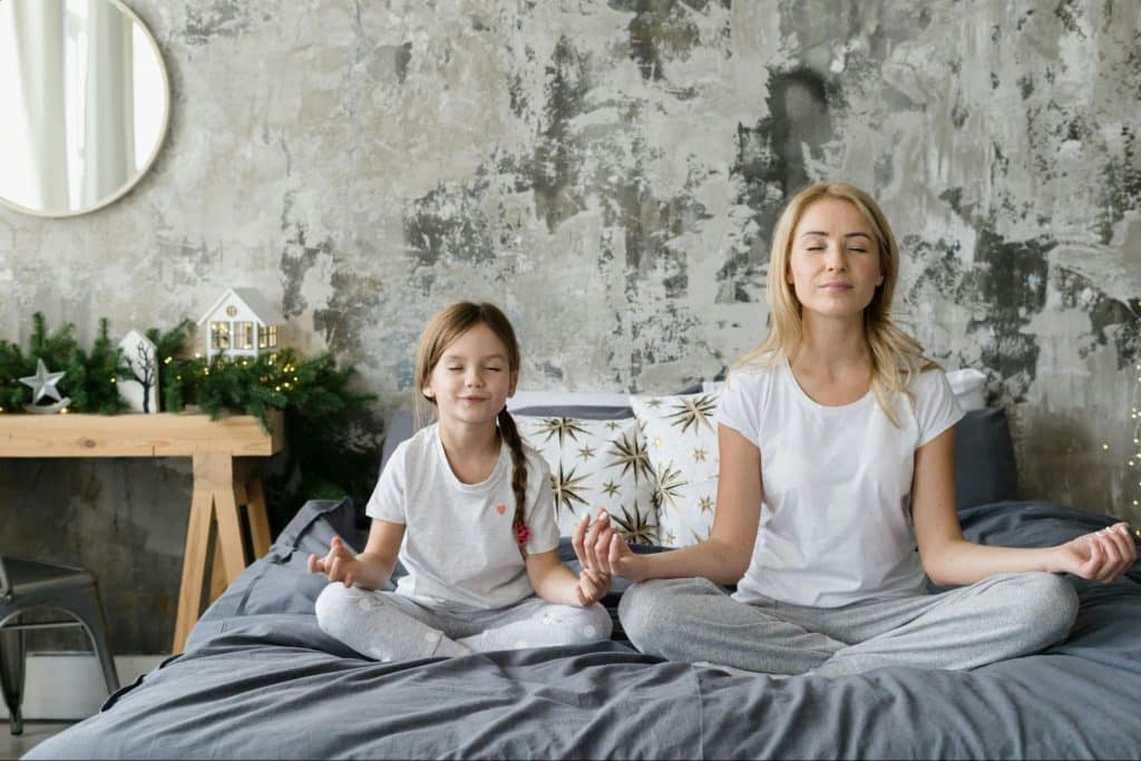 Caregiver and child sitting together calmly at home during a quiet moment