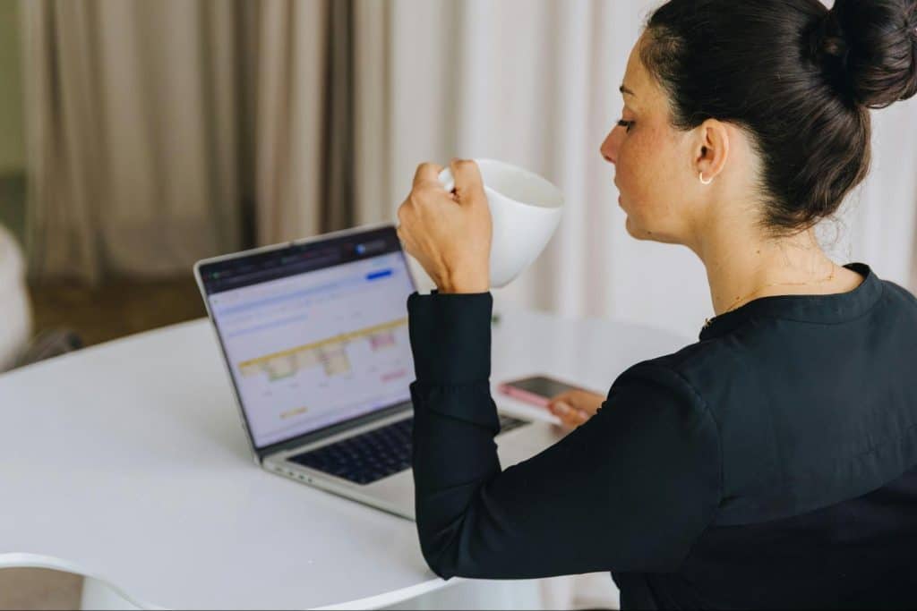 Caregiver working at a desk at home while managing daily responsibilities