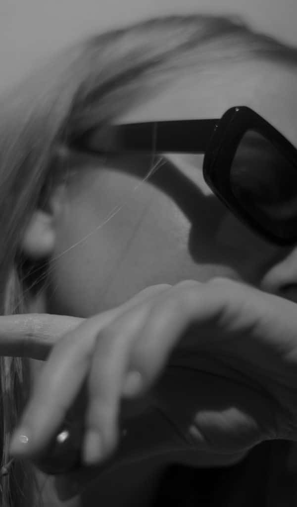 Close up of a woman in reflection, representing emotional complexity and uncertainty during a health diagnosis