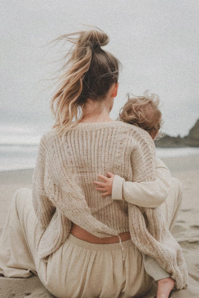 mother child beach embrace cozy day